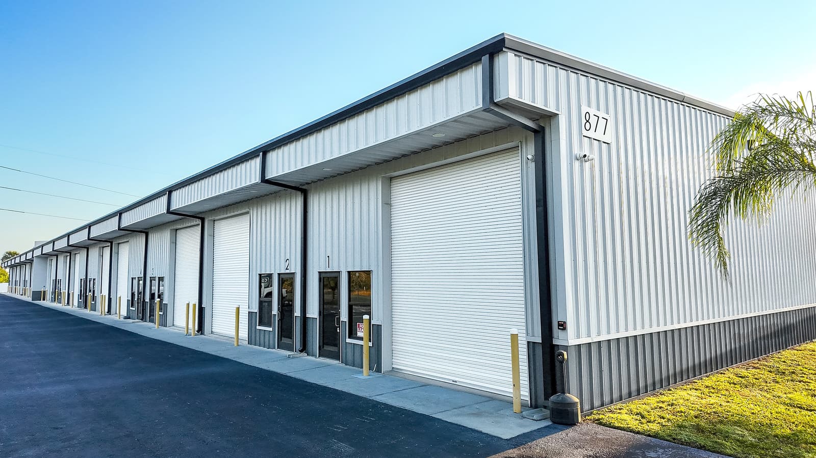 877 NE 27th Lane in Cape Coral, FL, a multi-tenant small-bay industrial building with roll-up doors